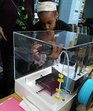 A female student checking out a science exhibit