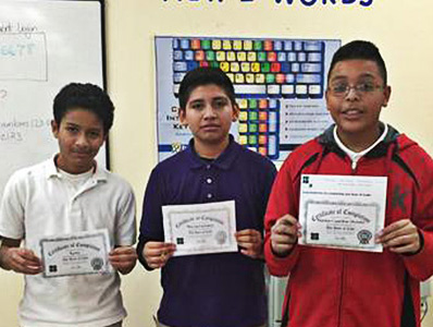 Students who completed the hour of code holding their certificates