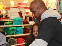 Washington Redskin London Fletcher shopping with DCPS student