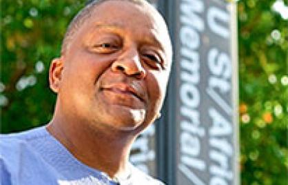 Father Payne in front of U street metro sign Father Payne in front of U street metro sign