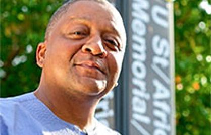 Father Payne in front of U street metro sign