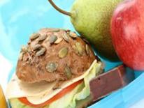 Photo of whole grain bread sandwich, a pear and an apple.