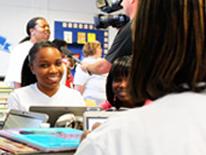 Photo of volunteer working with students in a classroom